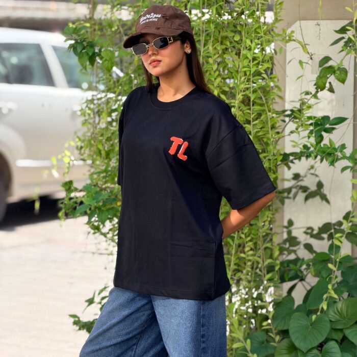 Black oversized t-shirt with owl face embroidery on back and amber eyes