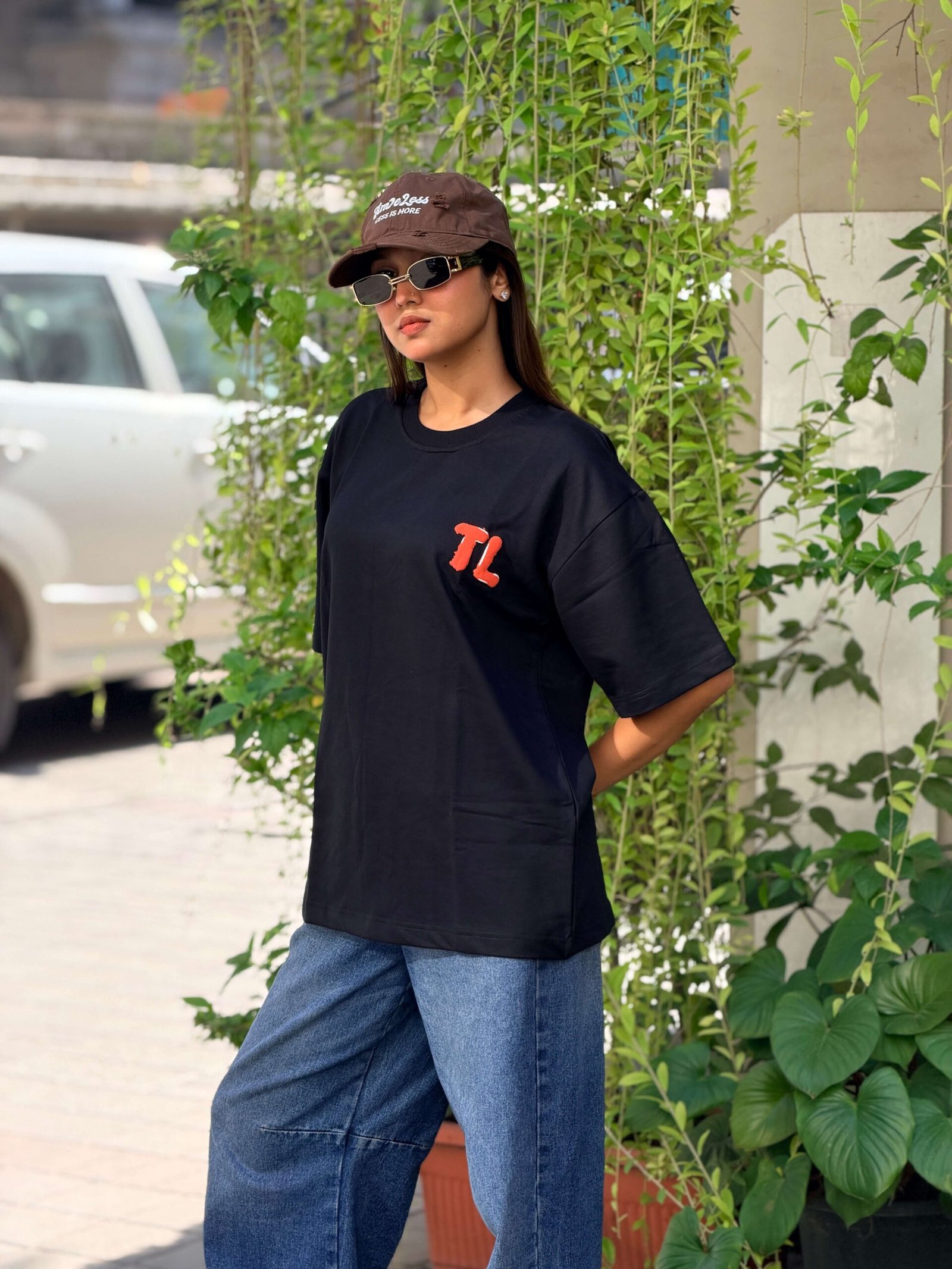 Black oversized t-shirt with owl face embroidery on back and amber eyes